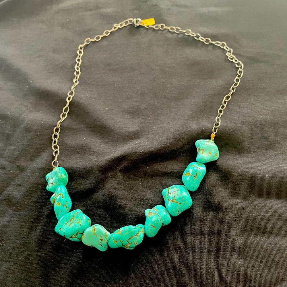 Tourquoise on a silver chain.